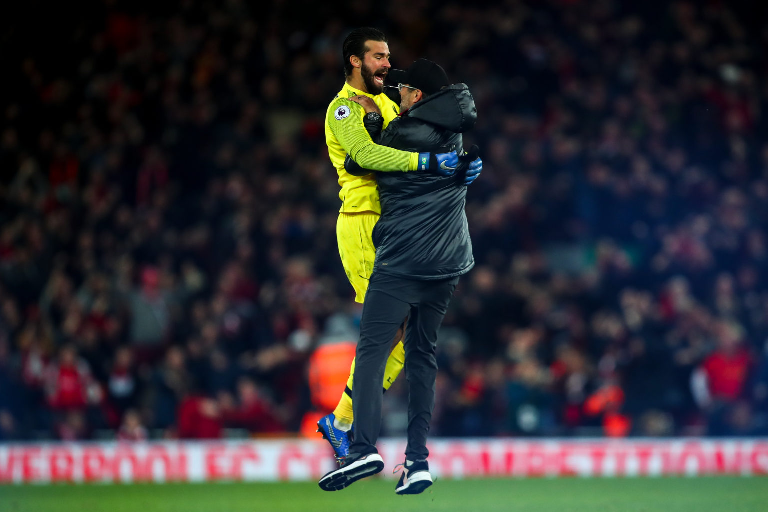 Jurgen Klopp the manager / head coach of Liverpool celebrates with Alisson Becker of Liverpool as Divock Origi of Liverpool scores a goal to make i...