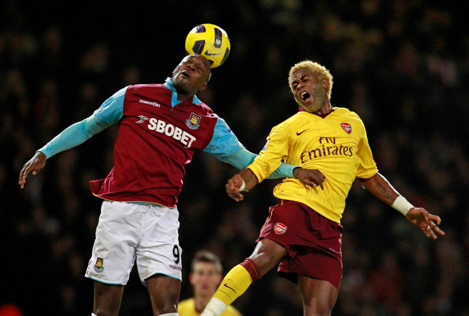 West Ham United's English striker Carlton Cole (L) vies with Arsenal's Cameroonian midfielder Alex Song (R) during the English Premier League footb...