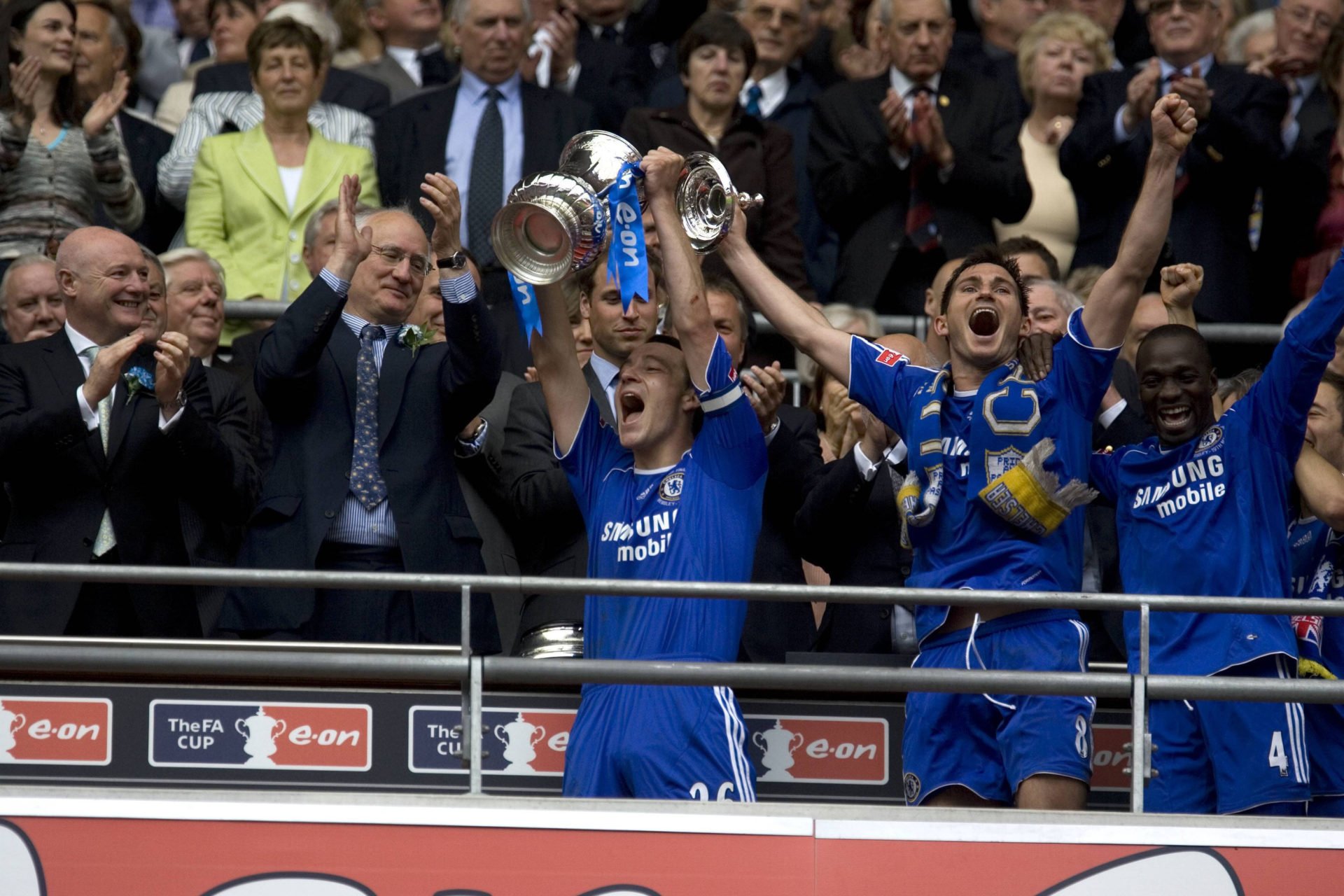 Prince William, President of the Football Association, watches John Terry and Frank Lampard of Chelsea F.C. hold up the FA Cup at the new Wembley S...