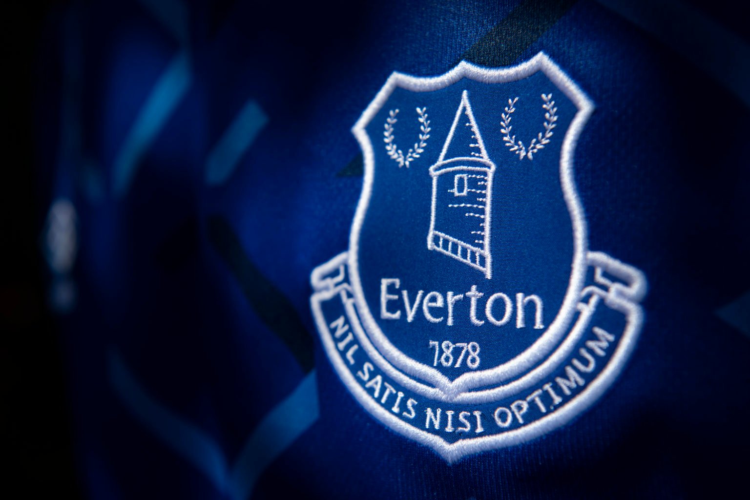 The Everton club crest on their first team home shirt on May 14, 2020 in Manchester, England.