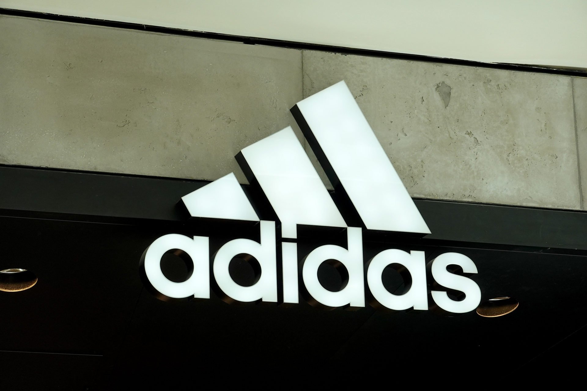 An Adidas sign at the entrance to the store on August 12, 2021 in Miami, Florida. Adidas is reported to have reached an agreement to sell its Reebo...