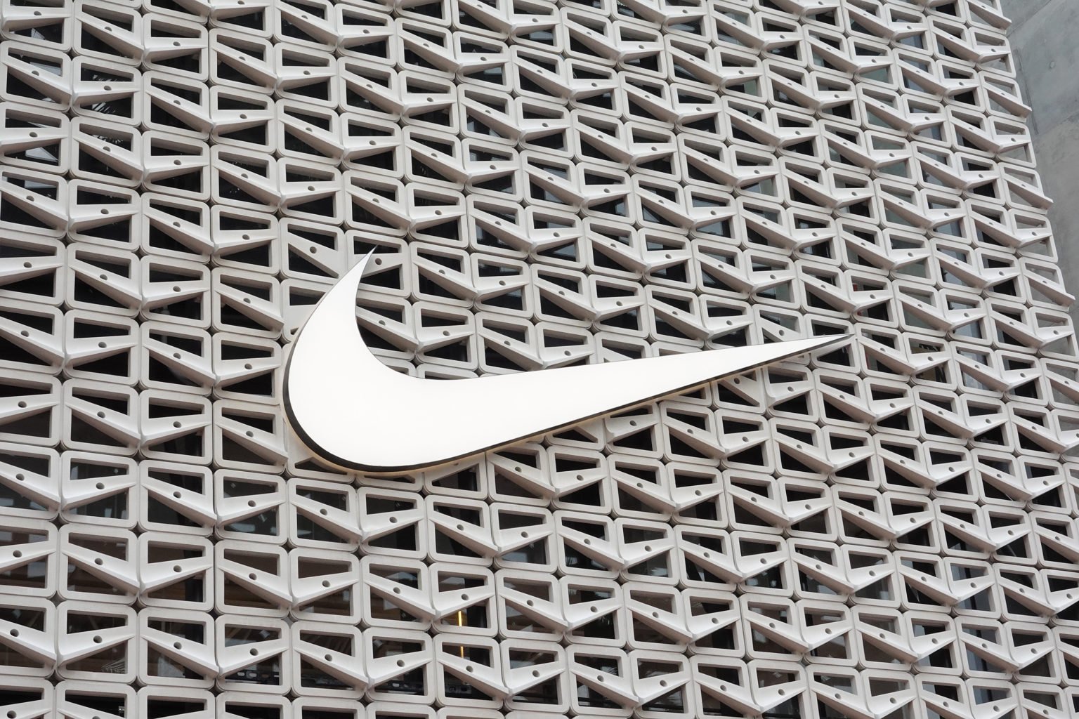 The Nike logo hangs above the entrance to the Nike store on December 21, 2021 in Miami Beach, Florida. Nike reported better-than-expected fiscal se...