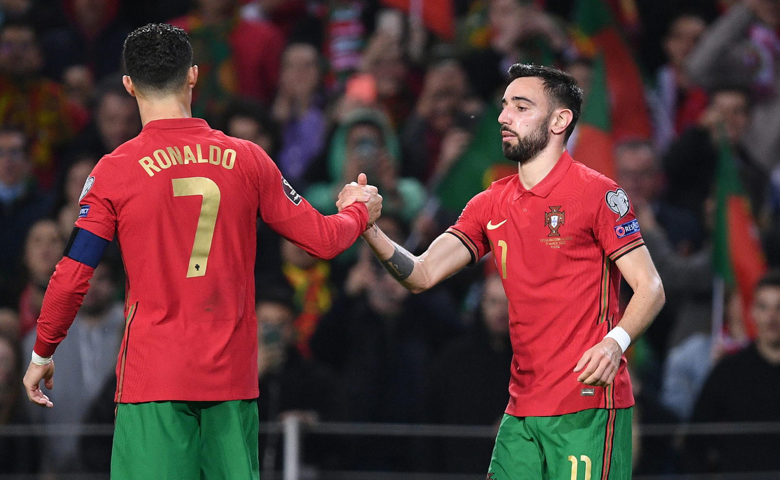 Bruno Fernandes celebrates with Cristiano Ronaldo of Portugal after scoring their team's second goal during the 2022 FIFA World Cup Qualifier knock...