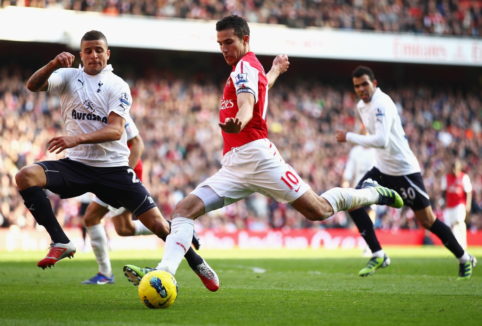 Robin van Persie of Arsenal is closed down by Kyle Walker of Tottenham Hotspur during the Barclays Premier League match between Arsenal and Tottenh...