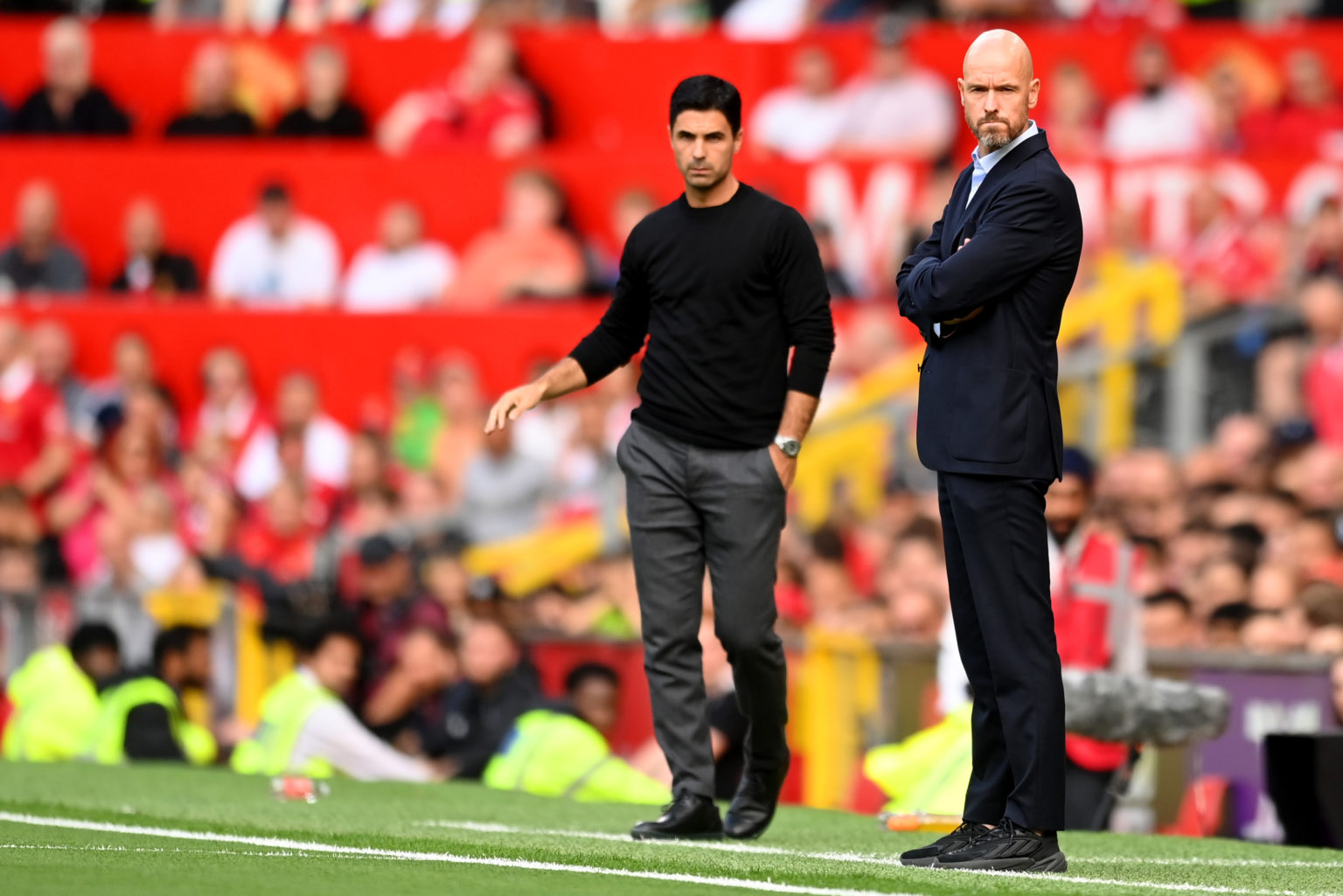 Mikel Arteta, Manager of Arsenal and Erik ten Hag, Manager of Manchester United look on during the Premier League match between Manchester United a...