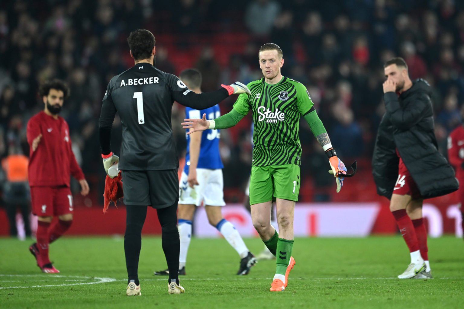 Alisson Becker of Liverpool and Jordan Pickford of Everton shake hands following the Premier League match between Liverpool FC and Everton FC at An...