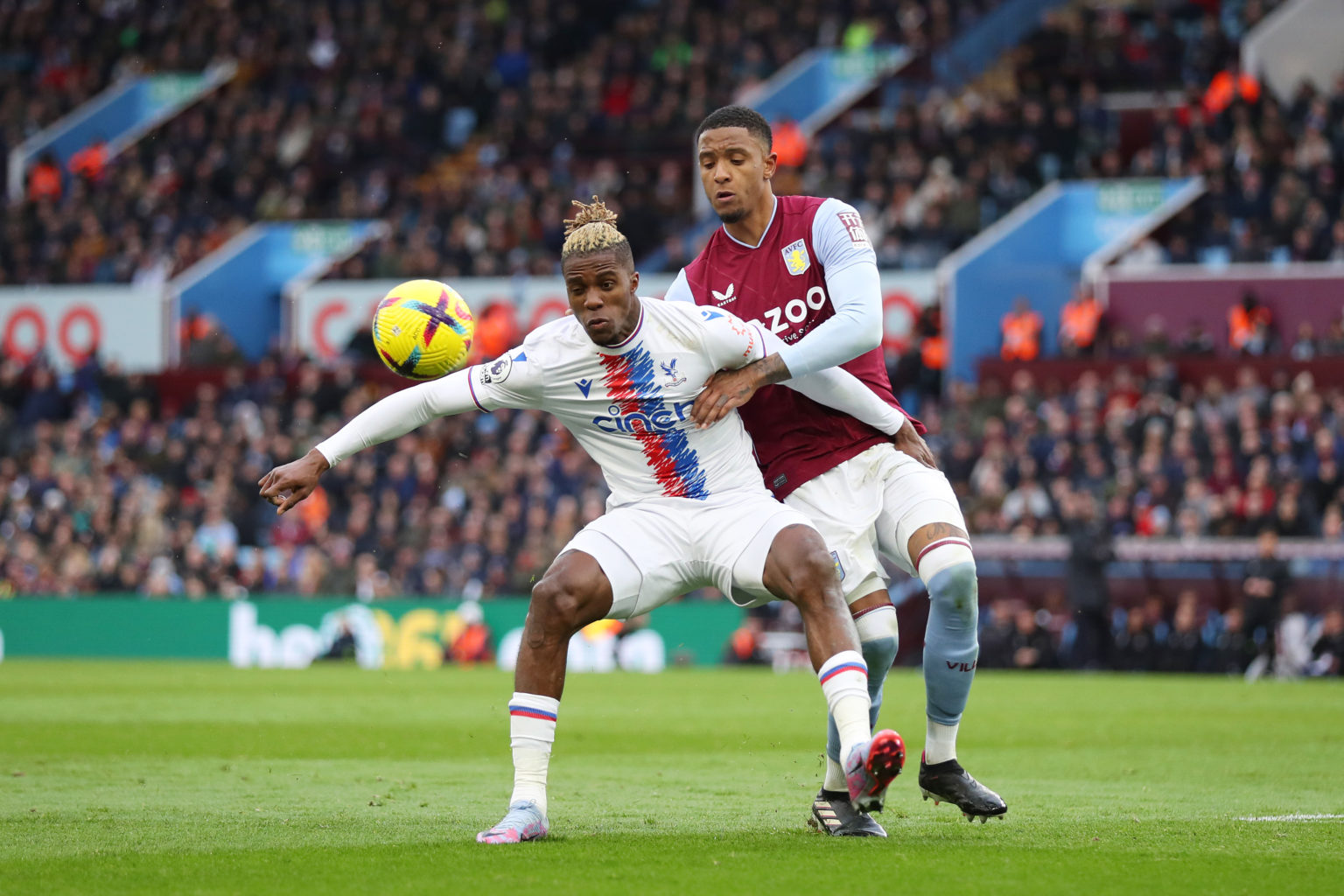 Wilfried Zaha of Crystal Palace and Ezri Konsa of Aston Villa battle for the ball during the Premier League match between Aston Villa and Crystal P...