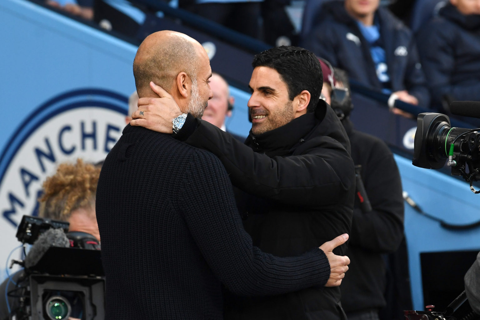 Mikel Arteta, Manager of Arsenal, embraces Pep Guardiola, Manager of Manchester City, prior to the Premier League match between Manchester City and...