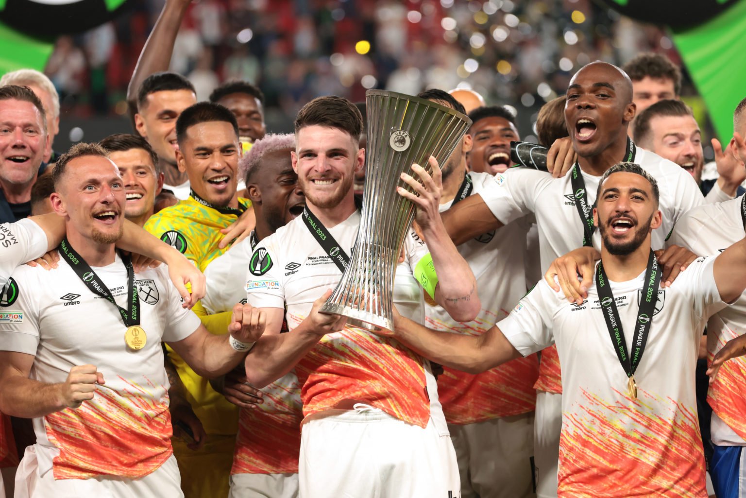 Declan Rice of West Ham United lifts the Winners' trophy as he celebrates with team mates on the podium following the UEFA Europa Conference League...