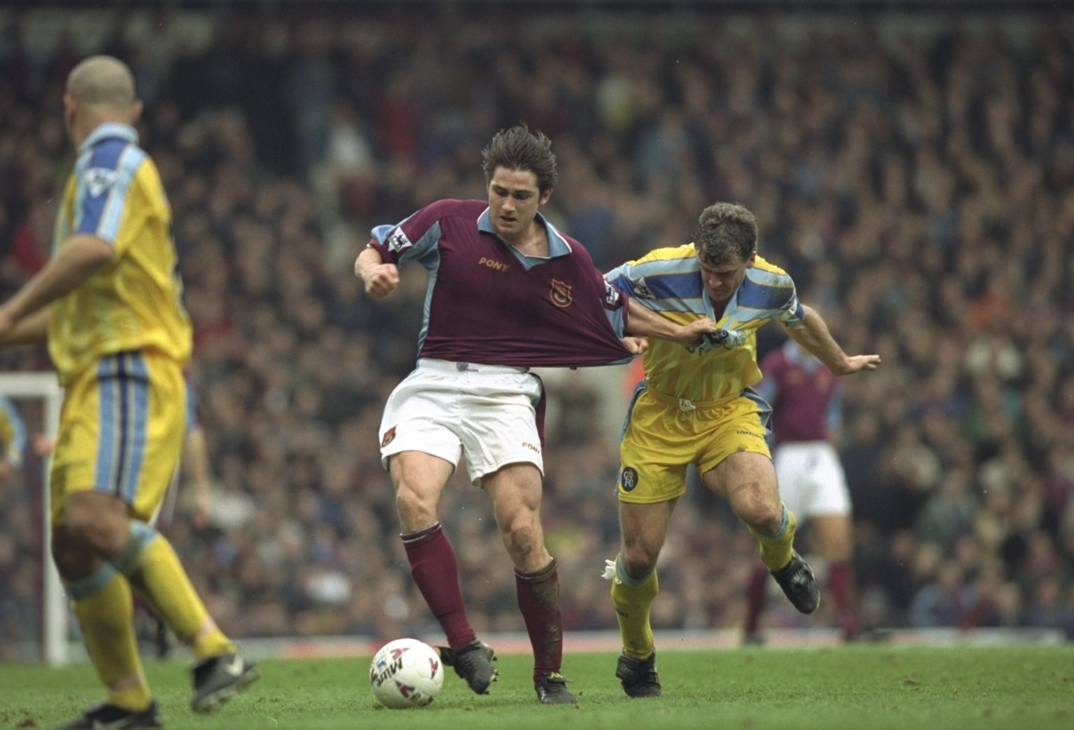 Frank Lompard of West Ham United (left) is held back by Mark Hughes of Chelsea during an FA Carling Premiership match at Upton Park in London. West...