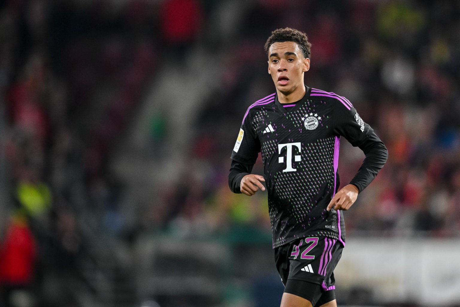 Jamal Musiala of Bayern Muenchen looks on during the Bundesliga match between 1. FSV Mainz 05 and FC Bayern München at MEWA Arena on October 21, 20...