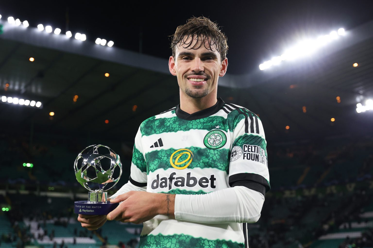 Matt O'Riley of Celtic poses for a photo with the PlayStation Player Of The Match award after the draw in the UEFA Champions League match between C...