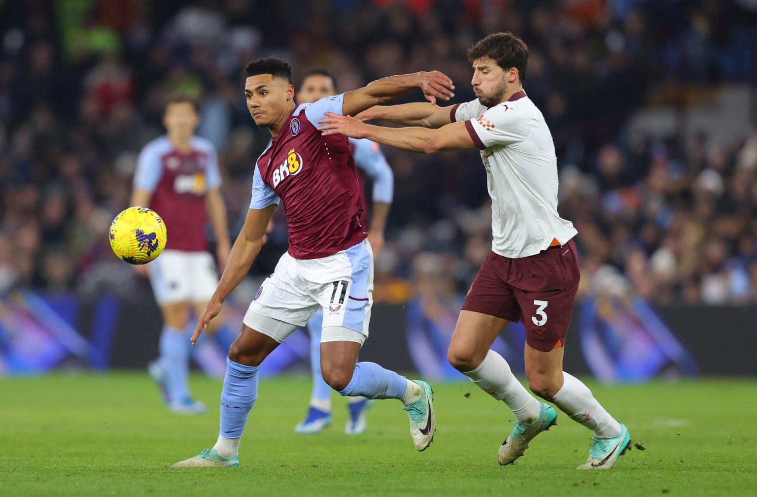 Ollie Watkins of Aston Villa beats Ruben Diasof Manchester City during the Premier League match between Aston Villa and Manchester City at Villa Pa...