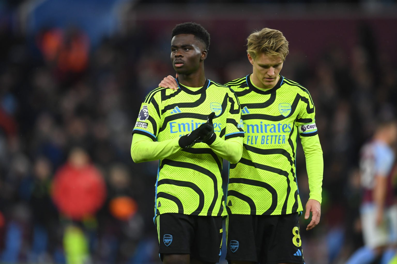 Bukayo Saka and Martin Odegaard of Arsenal look dejected following the team's defeat during the Premier League match between Aston Villa and Arsena...