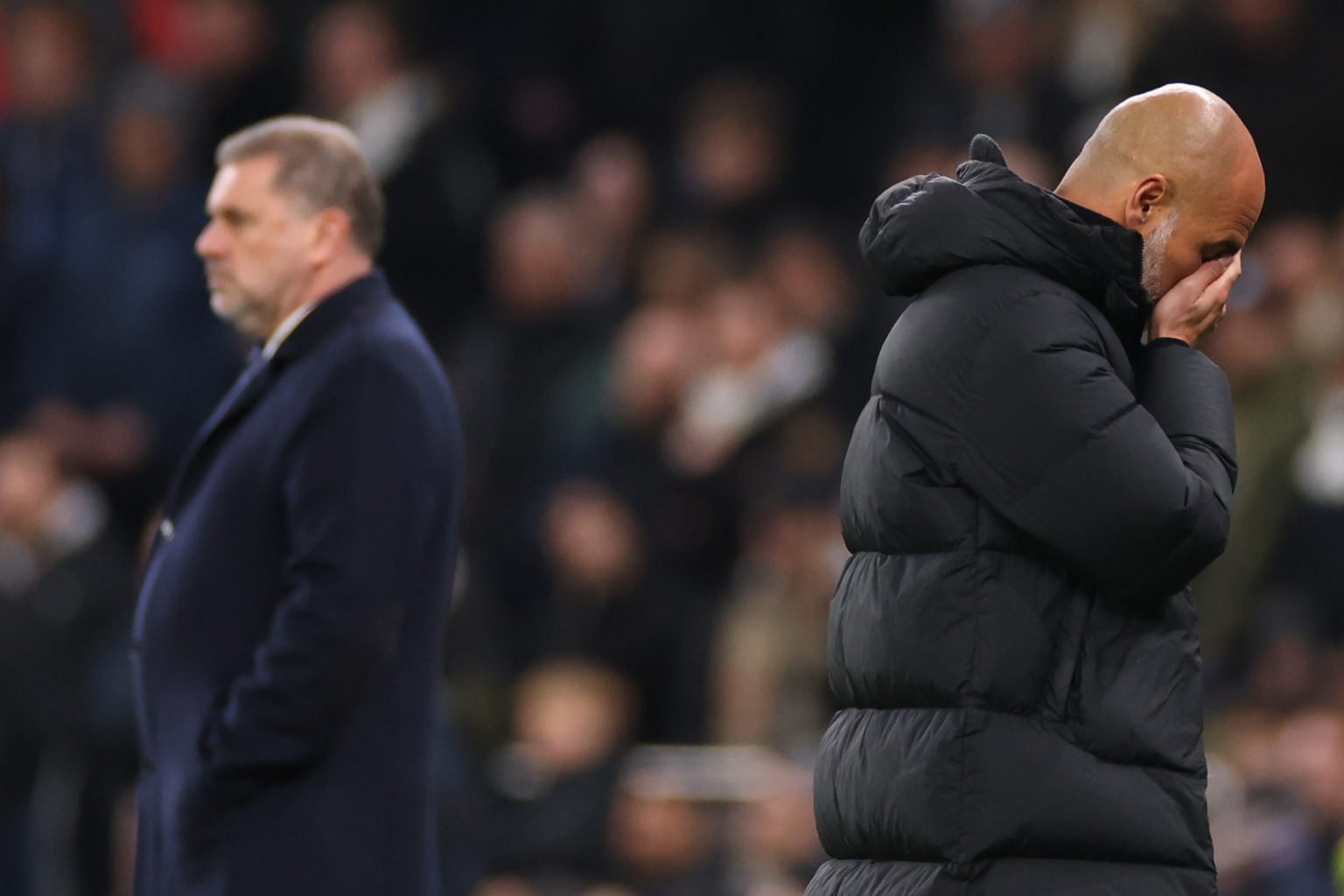 Pep Guardiola manager of Manchester City alongside Tottenham Hotspur Head Coach Ange Postecoglou during the Emirates FA Cup Fourth Round match betw...