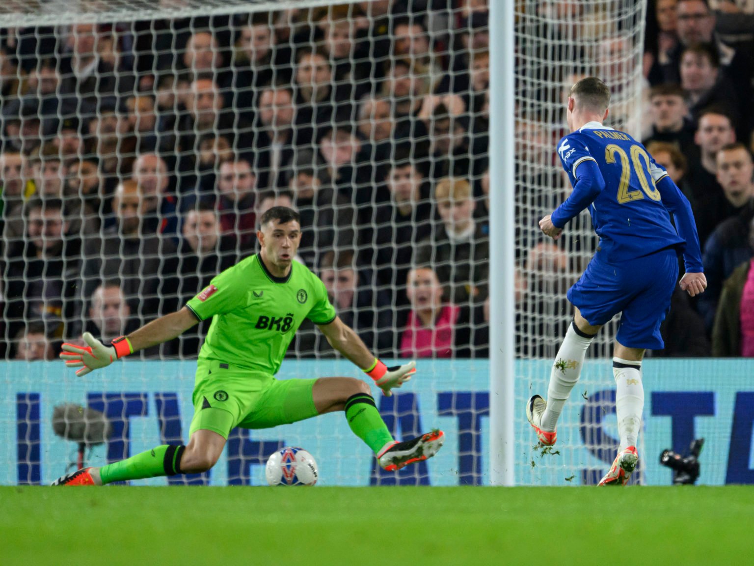 Chelsea's Cole Palmer (right) shot is on target but is saved by Aston Villa's Emiliano Martinez (left) during the Emirates FA Cup Fourth Round matc...