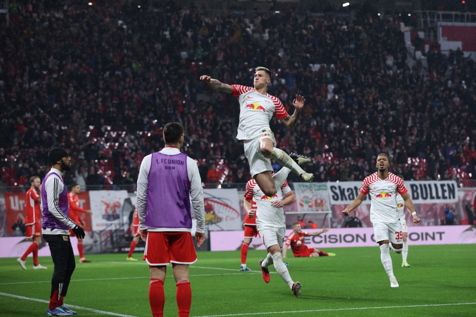 TOPSHOT - Leipzig's Slovenian forward #30 Benjamin Sesko (C) celebrates scoring the 2-0 goal with his team-mates during the German first division B...