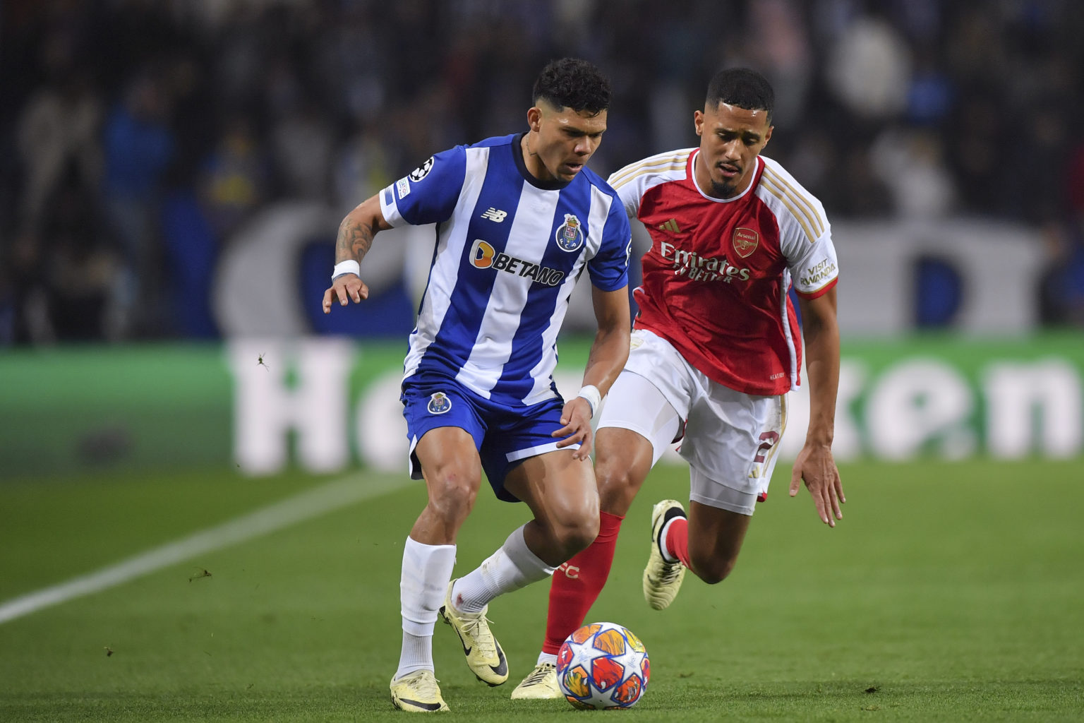 Evanilson de Lima of FC Porto (L) plays against William Saliba of Arsenal (R) during the UEFA Champions League 2023/24 round of 16 first leg match ...