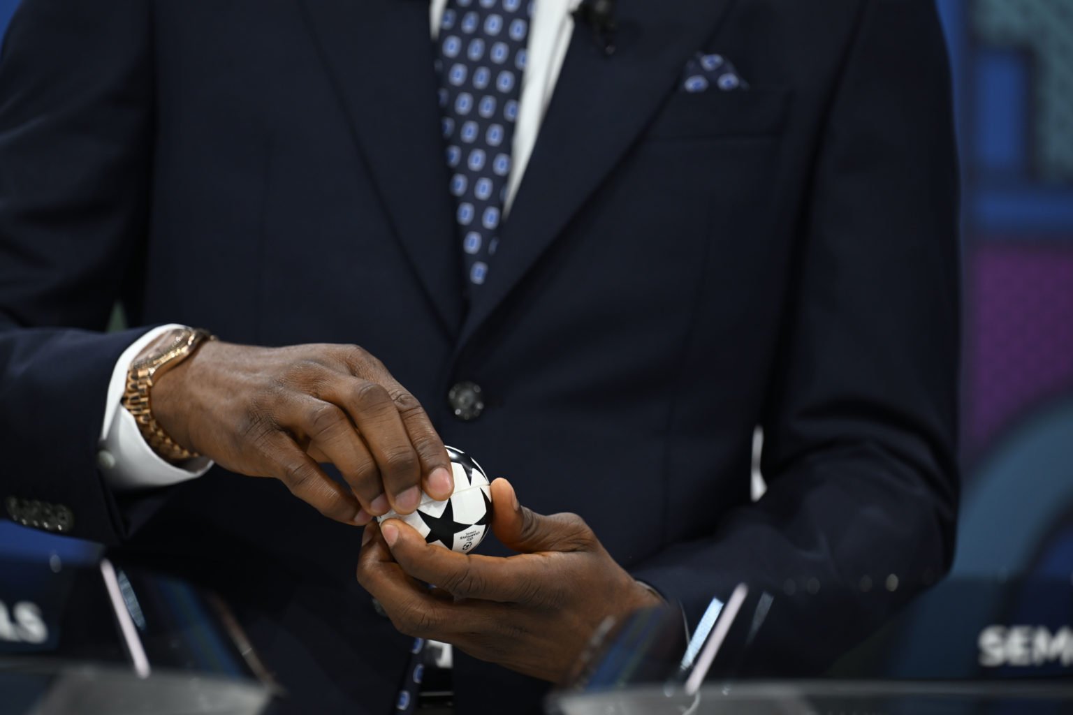 A detailed view of a draw ball being opened during the UEFA Champions League 2023/24 Quarter-finals And Semi-finals Draw at the UEFA Headquarters, ...