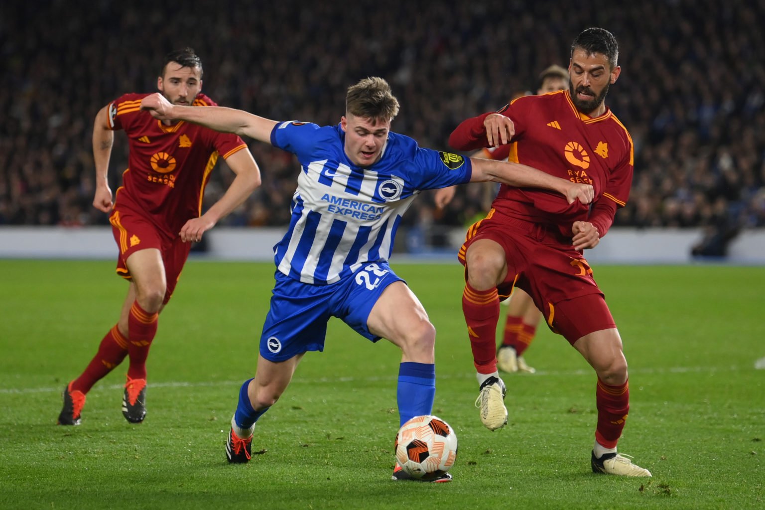 Evan Ferguson of Brighton holds off Leonardo Spinazzola of Roma during the UEFA Europa League 2023/24 round of 16 second leg match between Brighton...