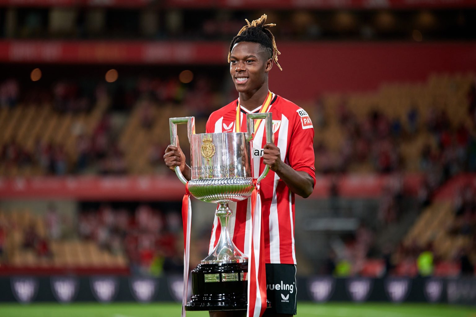 Nico Williams of Athletic Club poses with the Copa Del Rey trophy following his sides victory in the Copa Del Rey Final match between Athletic Club...