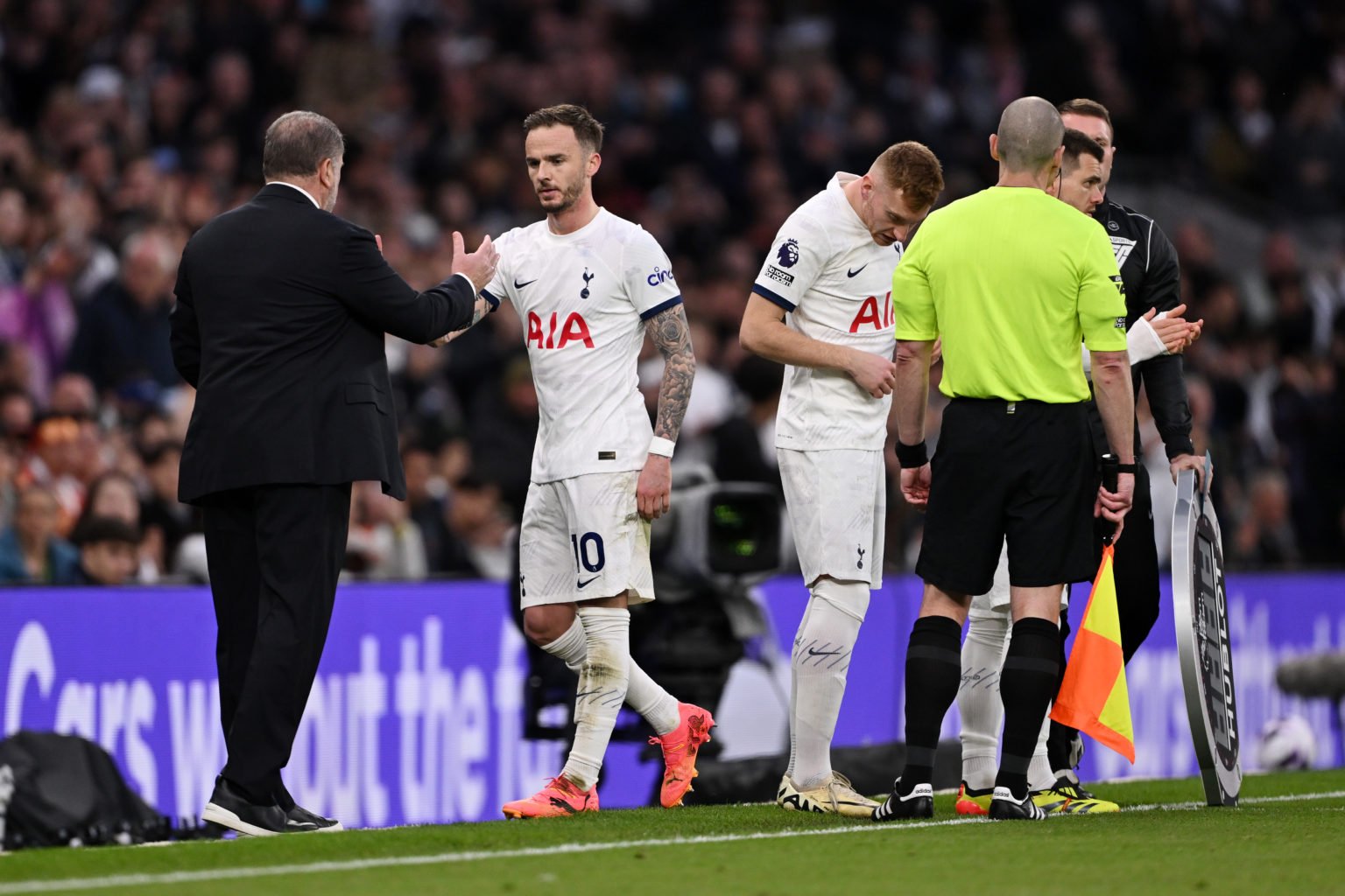 James Maddison of Tottenham Hotspur interacts with his manager Ange Postecoglou, Manager of Tottenham Hotspur, following substitution during the Pr...