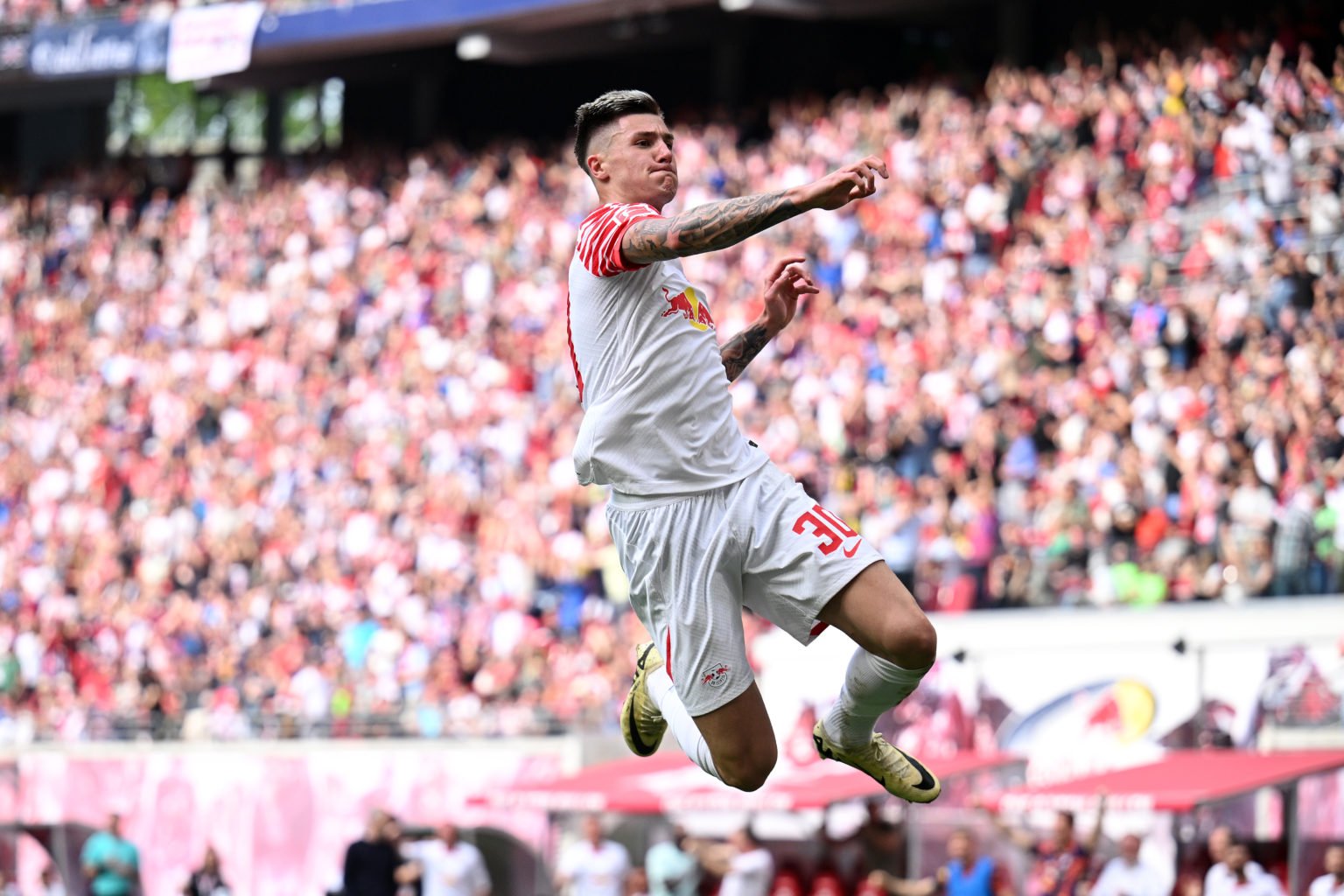 Benjamin Sesko of RB Leipzig celebrates scoring his team's second goal during the Bundesliga match between RB Leipzig and VfL Wolfsburg at Red Bull...