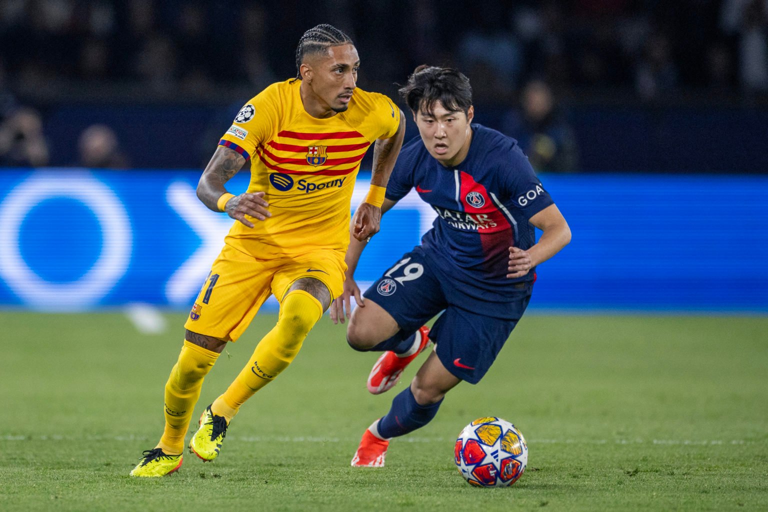 Raphinha #11 of Barcelona defended by Lee Kang-In #19 of Paris Saint-Germain during the Paris Saint-Germain V Barcelona, UEFA Champions League, Qua...