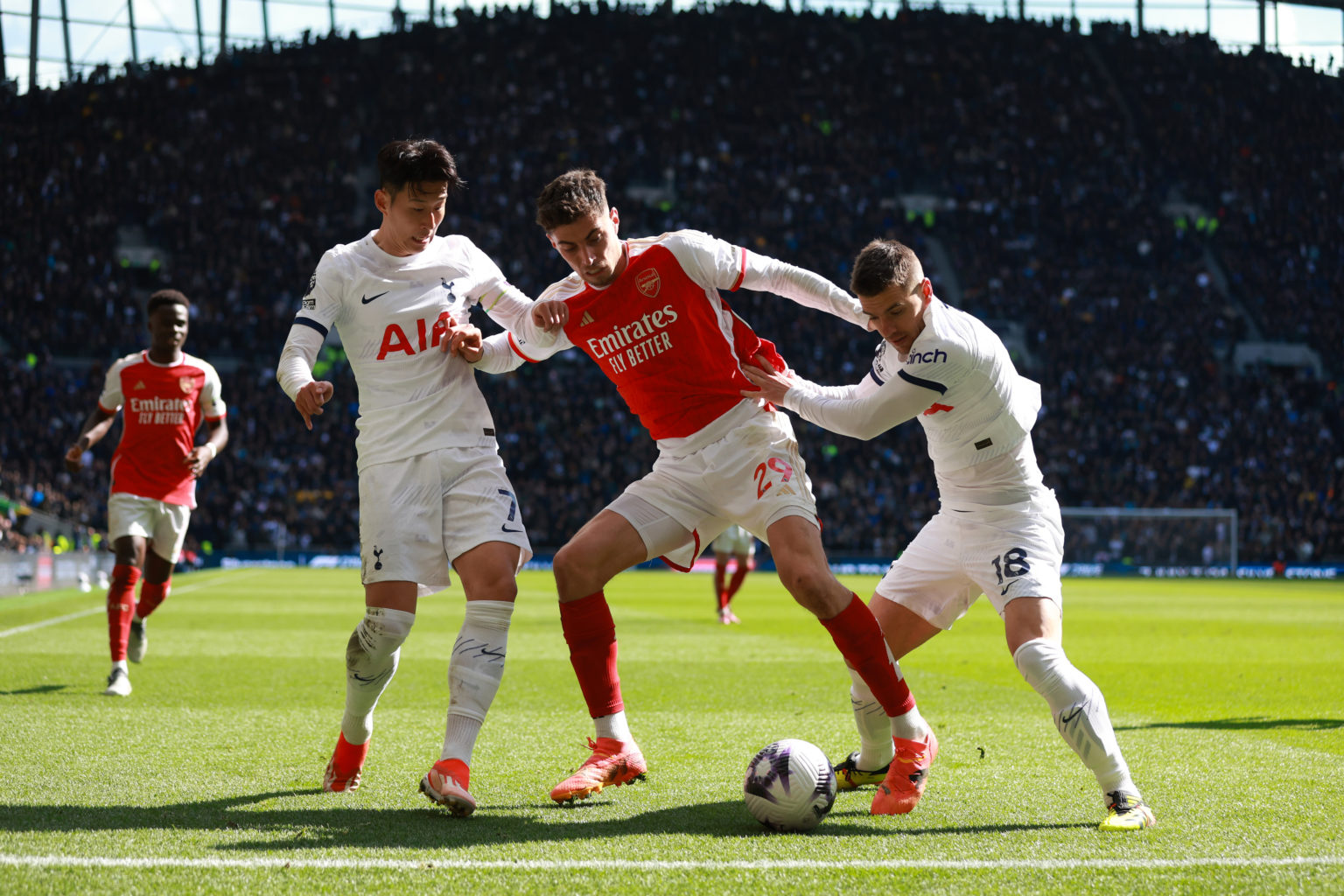 Kai Havertz of Arsenal holds off Son Heung-min and Giovani Lo Celso of Tottenham Hotspur during the Premier League match between Tottenham Hotspur ...