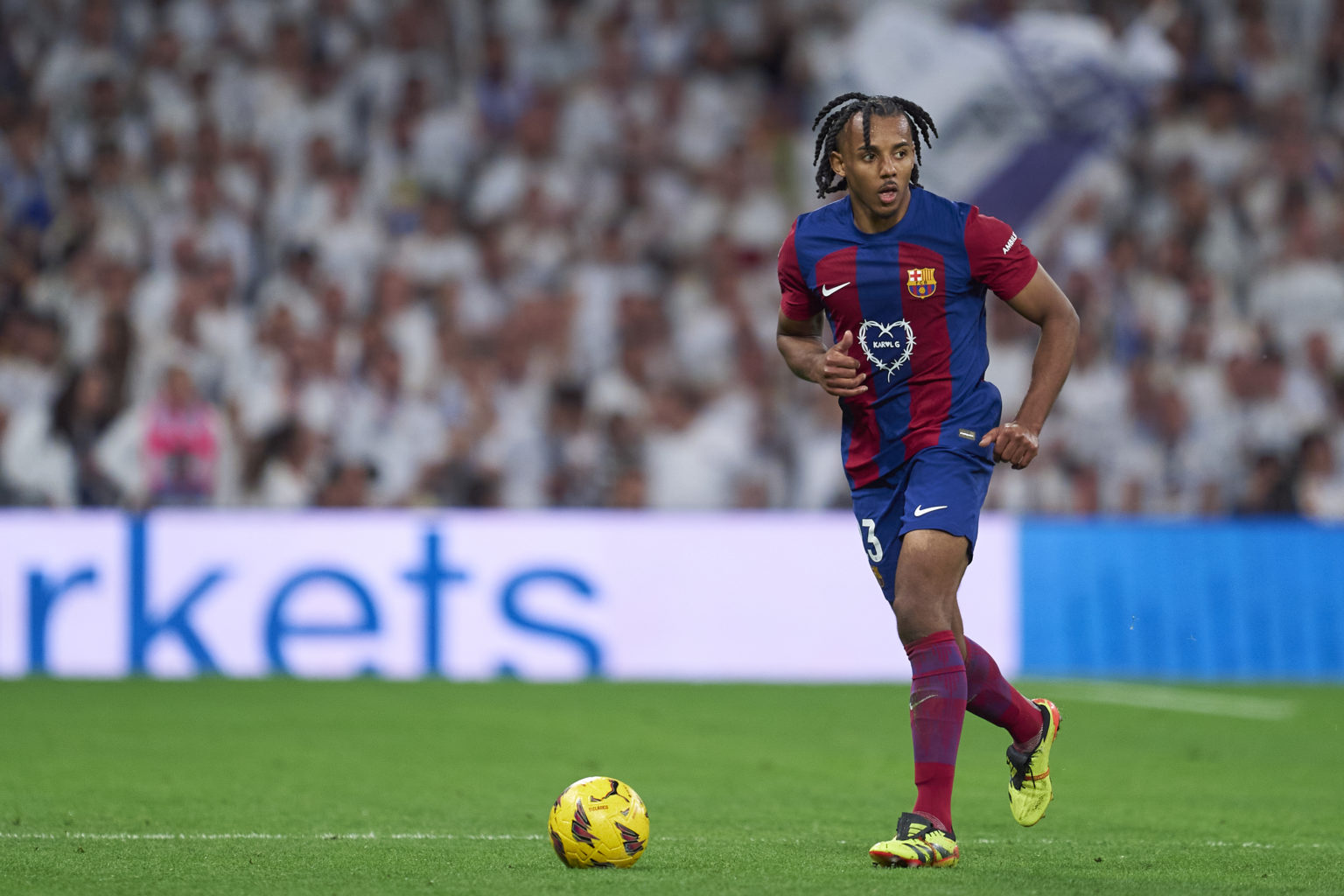 Jules Kounde of FC Barcelona with the ball during the LaLiga EA Sports match between Real Madrid CF and FC Barcelona at Estadio Santiago Bernabeu o...