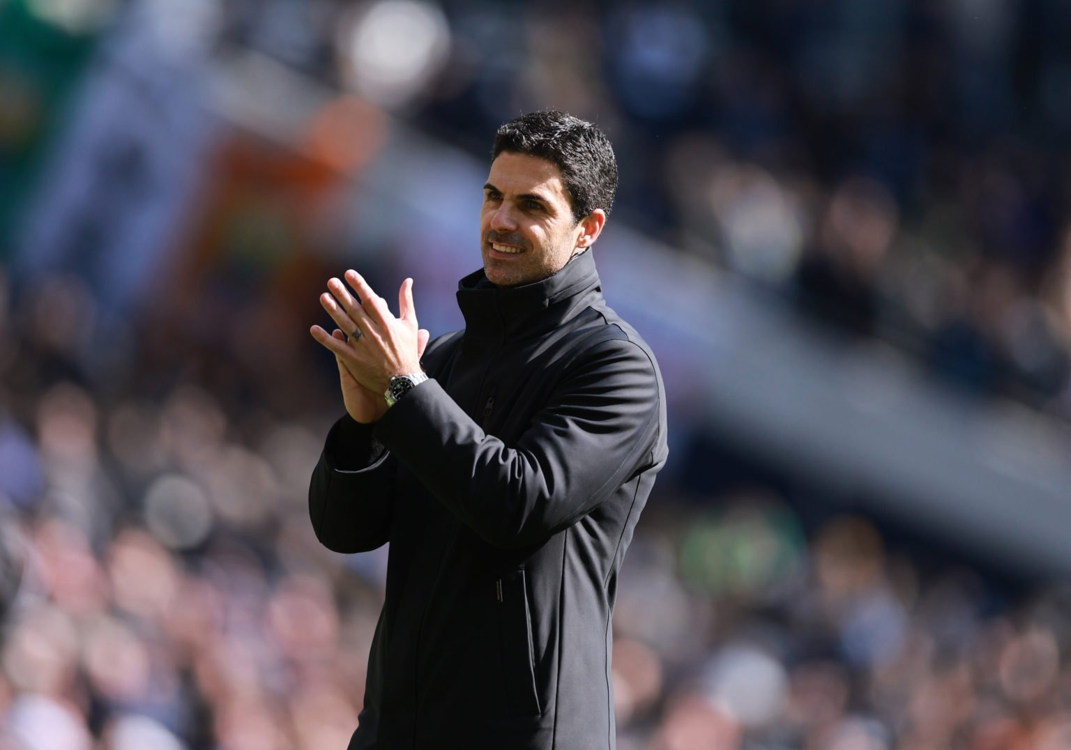 A smiling Mikel Arteta the head coach / manager of Arsenal applauds the fans after the Premier League match between Tottenham Hotspur and Arsenal F...