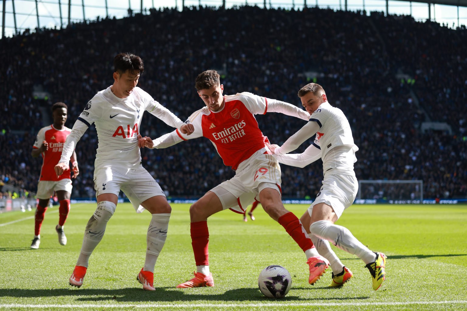 Kai Havertz of Arsenal holds off Son Heung-min and Giovani Lo Celso of Tottenham Hotspur  during the Premier League match between Tottenham Hotspur...