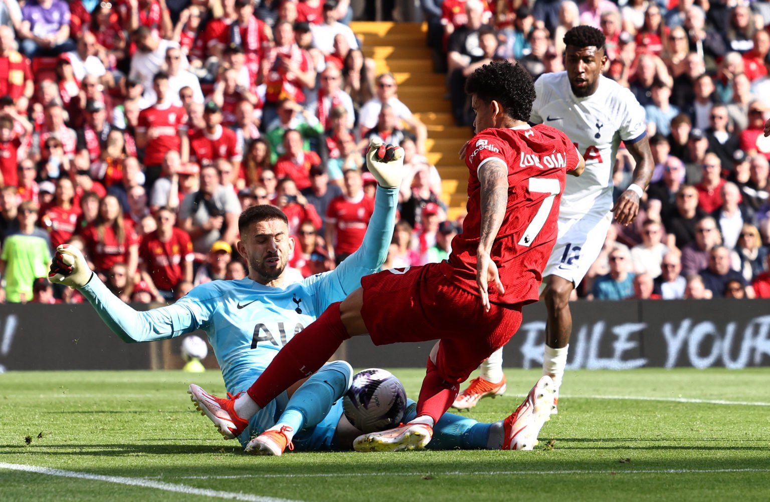 Tottenham Hotspur's Italian goalkeeper #13 Guglielmo Vicario saves from the feet of Liverpool's Colombian midfielder #07 Luis Diaz during the Engli...