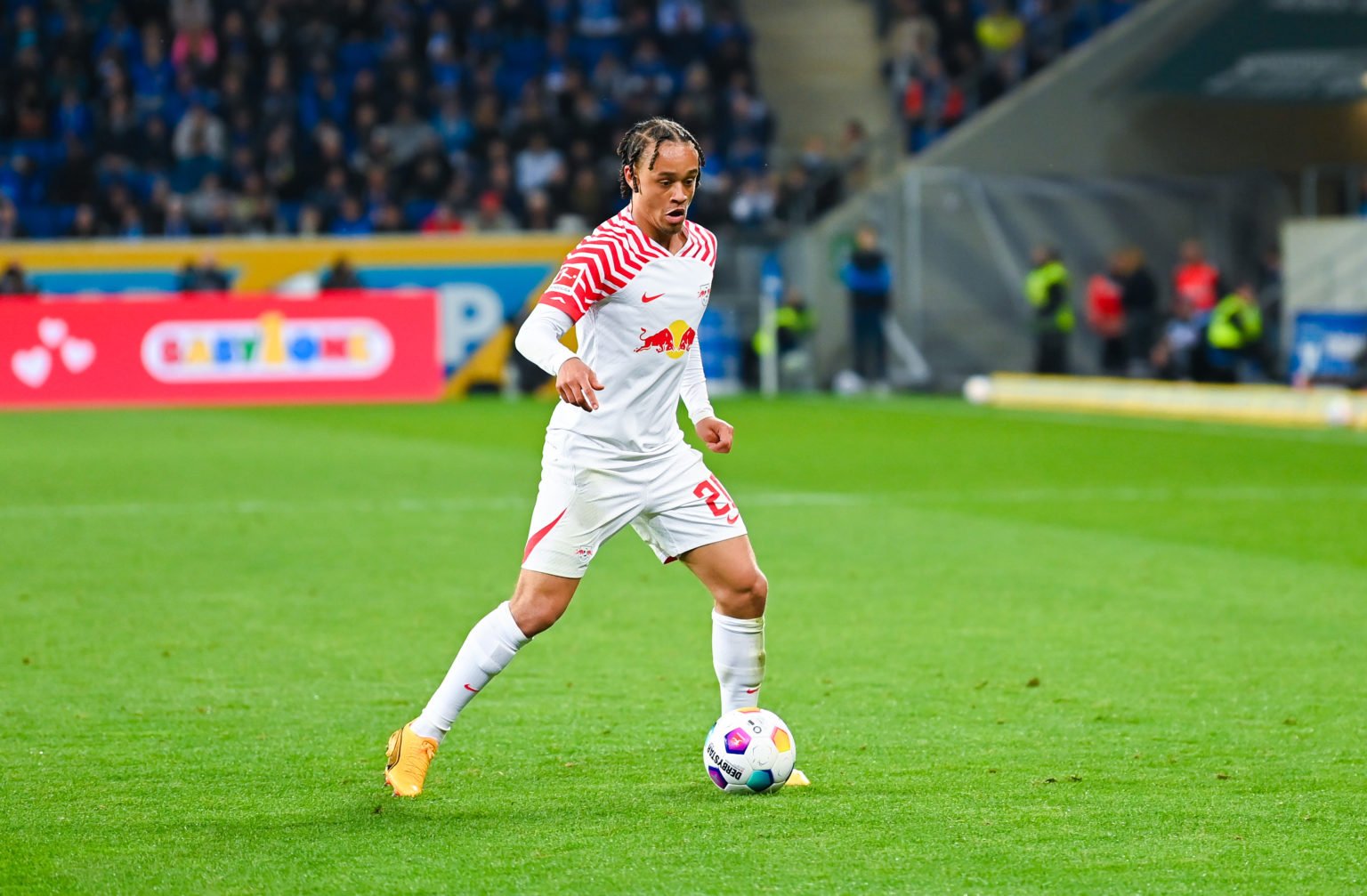 Xavi Simons of RB Leipzig controls the ball during the Bundesliga match between TSG Hoffenheim and RB Leipzig at PreZero-Arena on May 3, 2024 in Si...