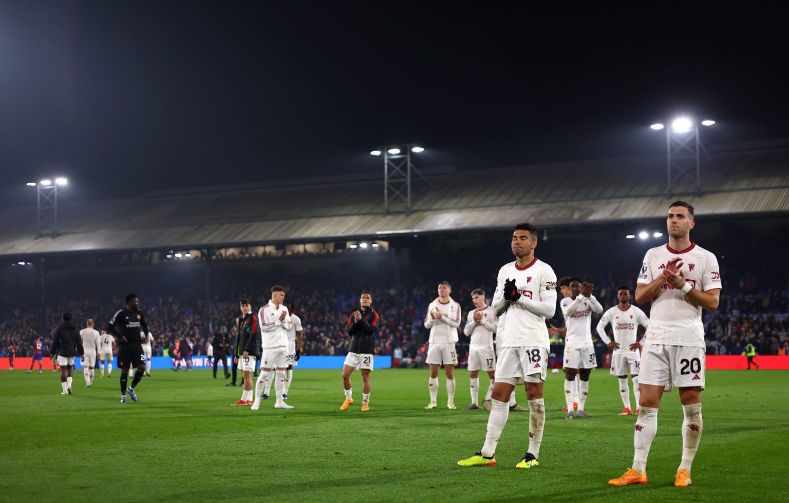 Casemiro and Diogo Dalot of Manchester United applaud the fans after the Premier League match between Crystal Palace and Manchester United at Selhu...