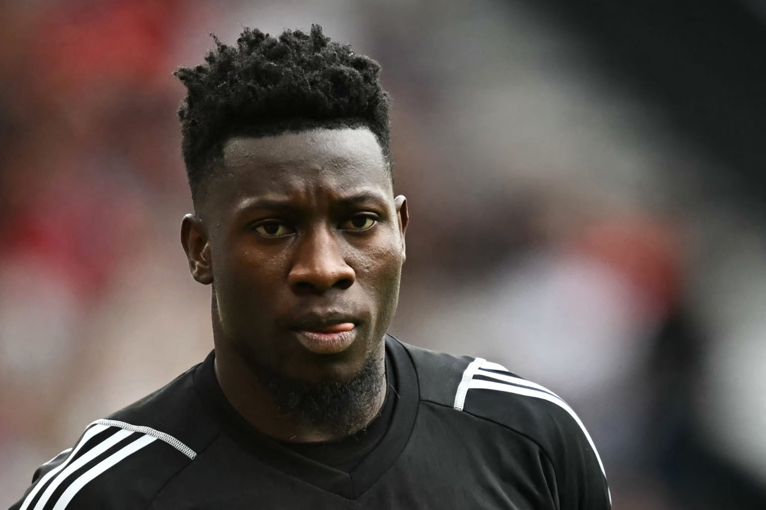 Manchester United's Cameroonian goalkeeper #24 Andre Onana reacts during the English Premier League football match between Manchester United and Ar...