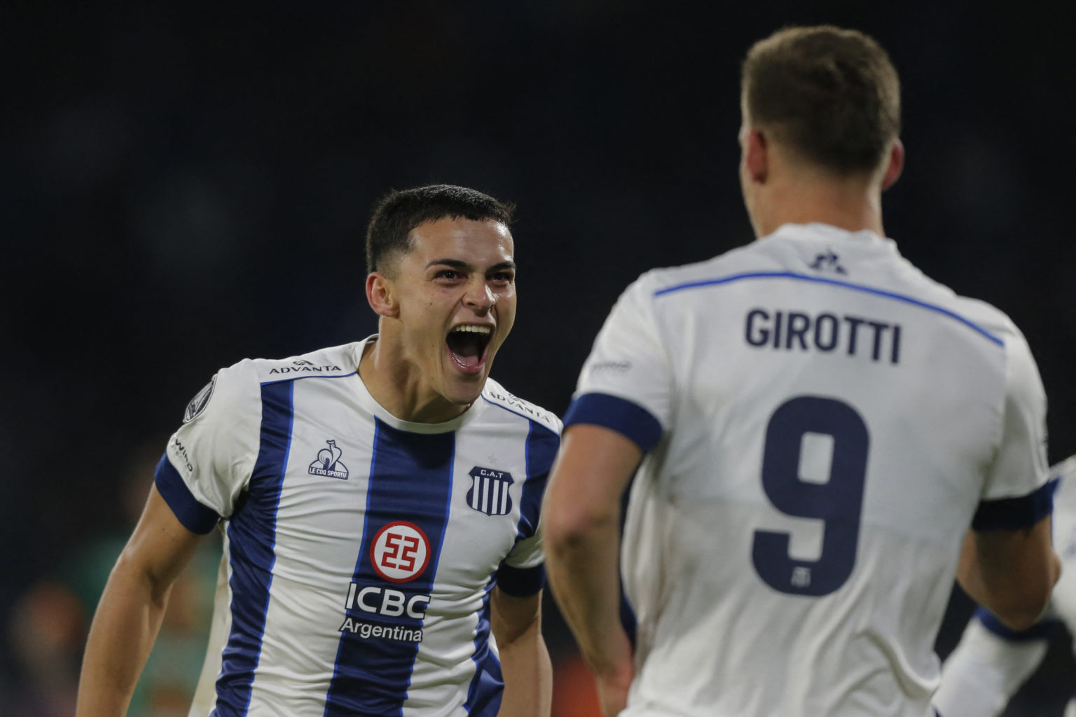 Talleres' forward Federico Girotti (R) celebrates with Talleres' Paraguayan forward Ramon Sosa after scoring during the Copa Libertadores group sta...