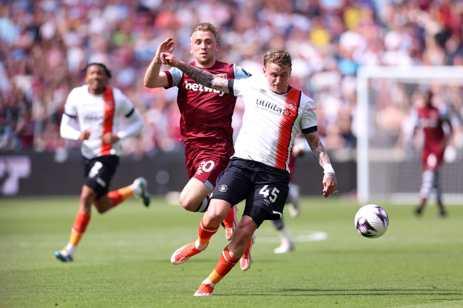 Alfie Doughty of Luton Town is challenged by Jarrod Bowen of West Ham United during the Premier League match between West Ham United and Luton Town...