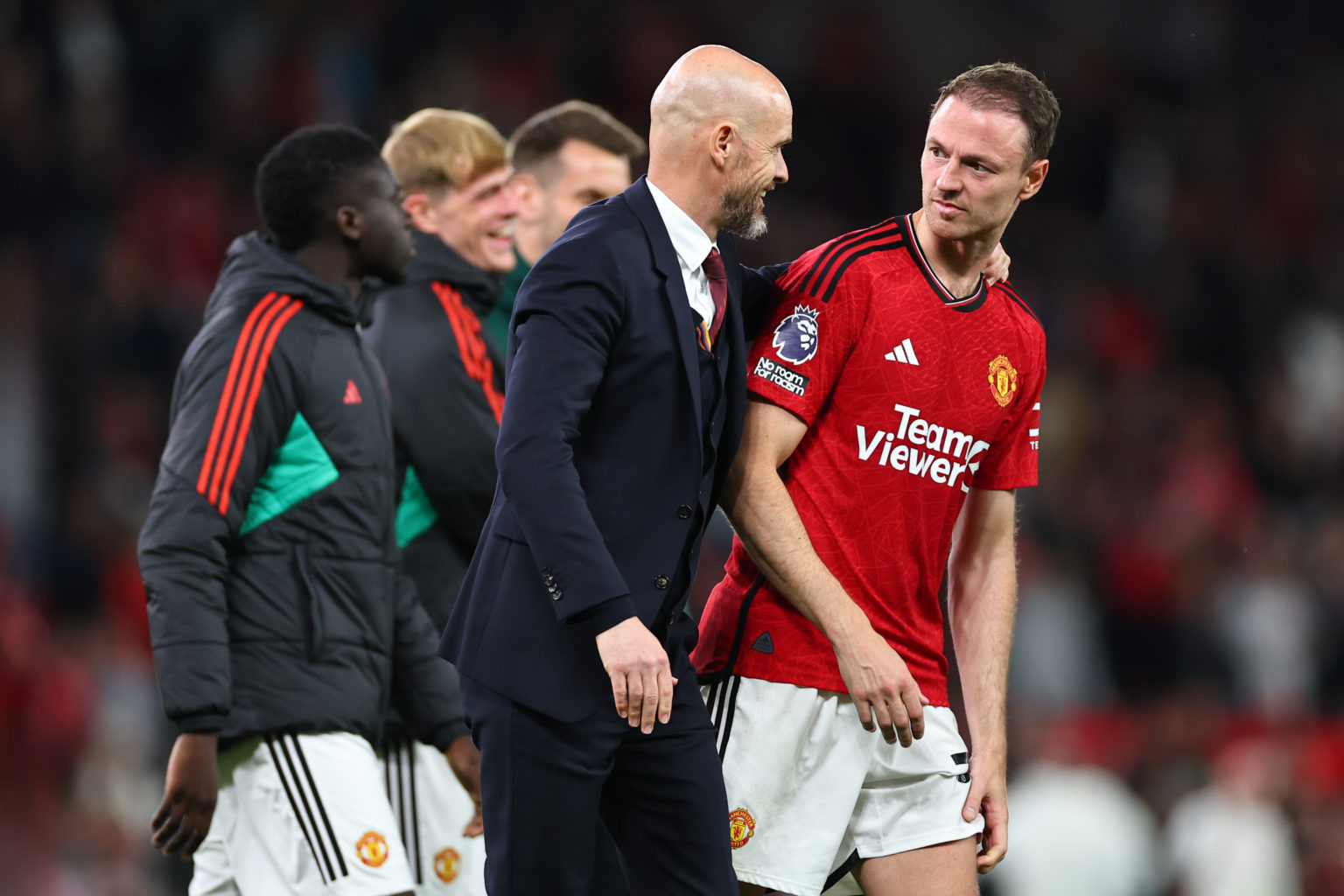 Erik ten Hag the head coach / manager of Manchester United at full time with Jonny Evans  during the Premier League match between Manchester United...