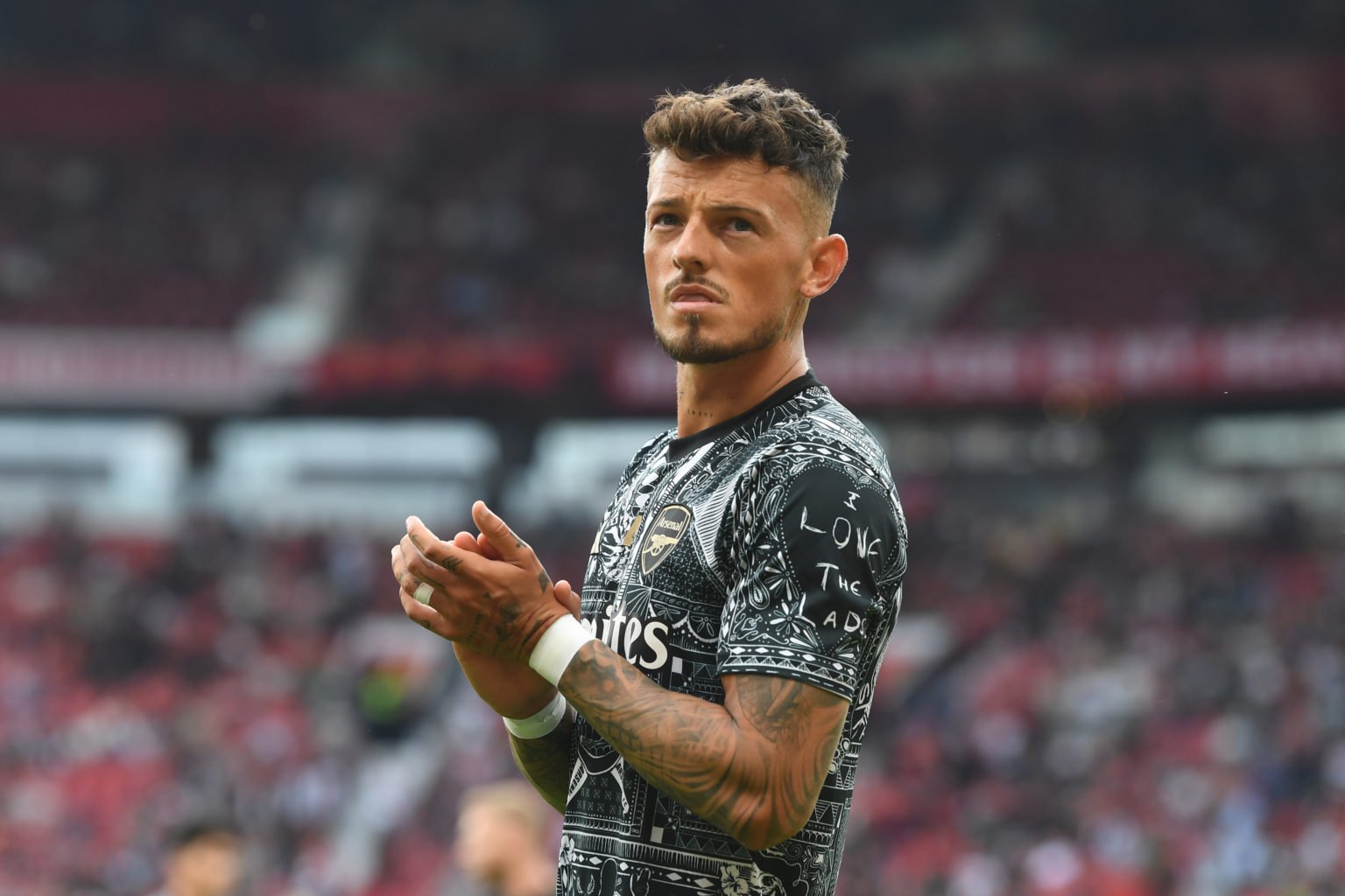 Ben White of Arsenal applauds the fans as he warms up prior to the Premier League match between Manchester United and Arsenal FC at Old Trafford on...