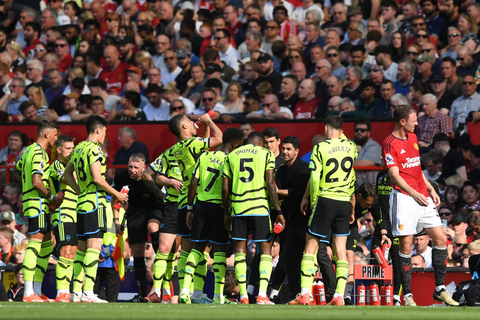 Mikel Arteta, Manager of Arsenal, speaks with players of Arsenal as they pause for a drinks break during the Premier League match between Mancheste...