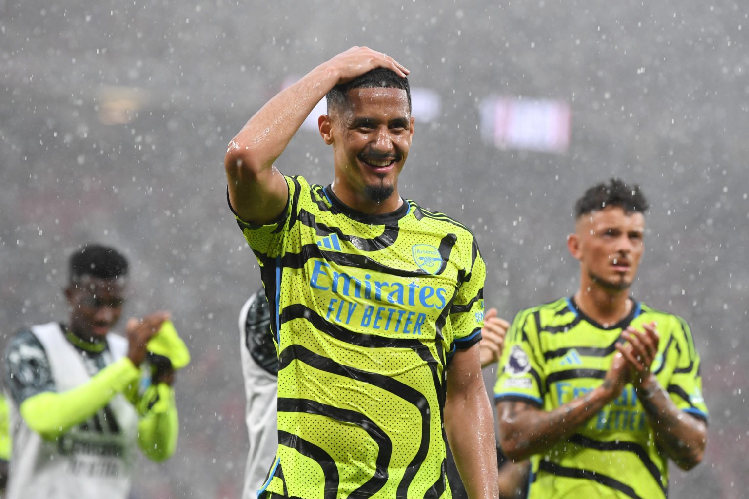 William Saliba of Arsenal celebrates victory with teammates after the Premier League match between Manchester United and Arsenal FC at Old Trafford...