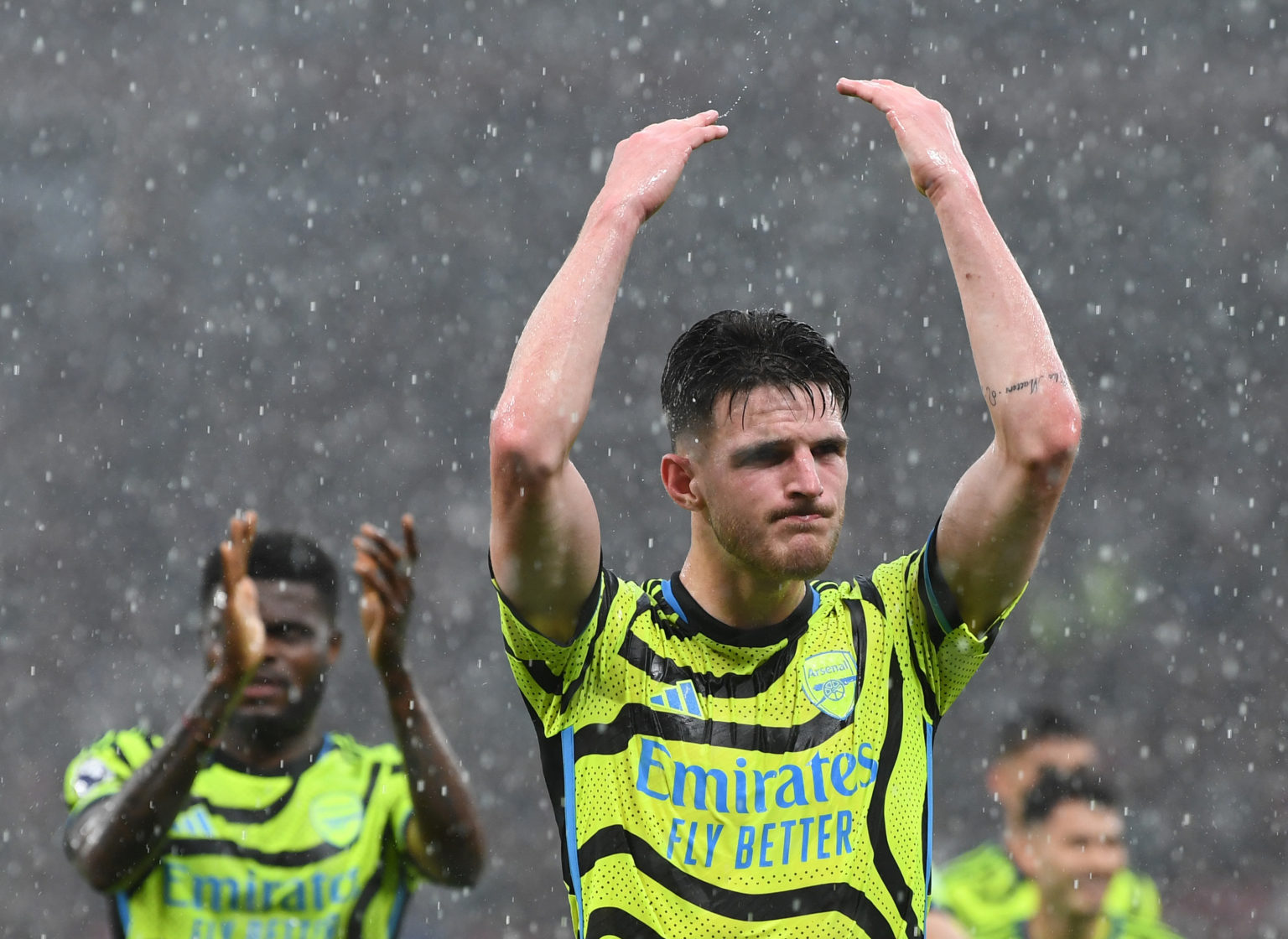 Declan Rice of Arsenal acknowledges the fans as he celebrates victory with teammates after defeating Manchester United during the Premier League ma...