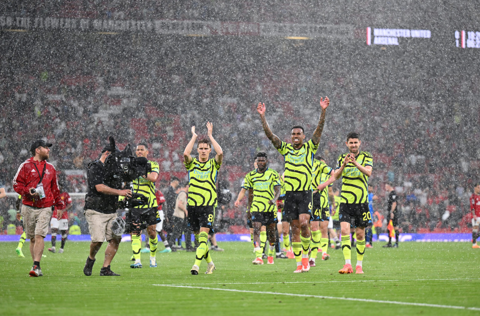 Arsenal players celebrate after the Premier League match between Manchester United and Arsenal FC at Old Trafford on May 12, 2024 in Manchester, En...