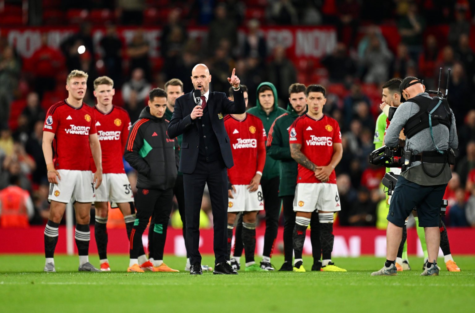 Erik ten Hag, Manager of Manchester United, speaks to the fans on the pitch after the team's victory during the Premier League match between Manche...