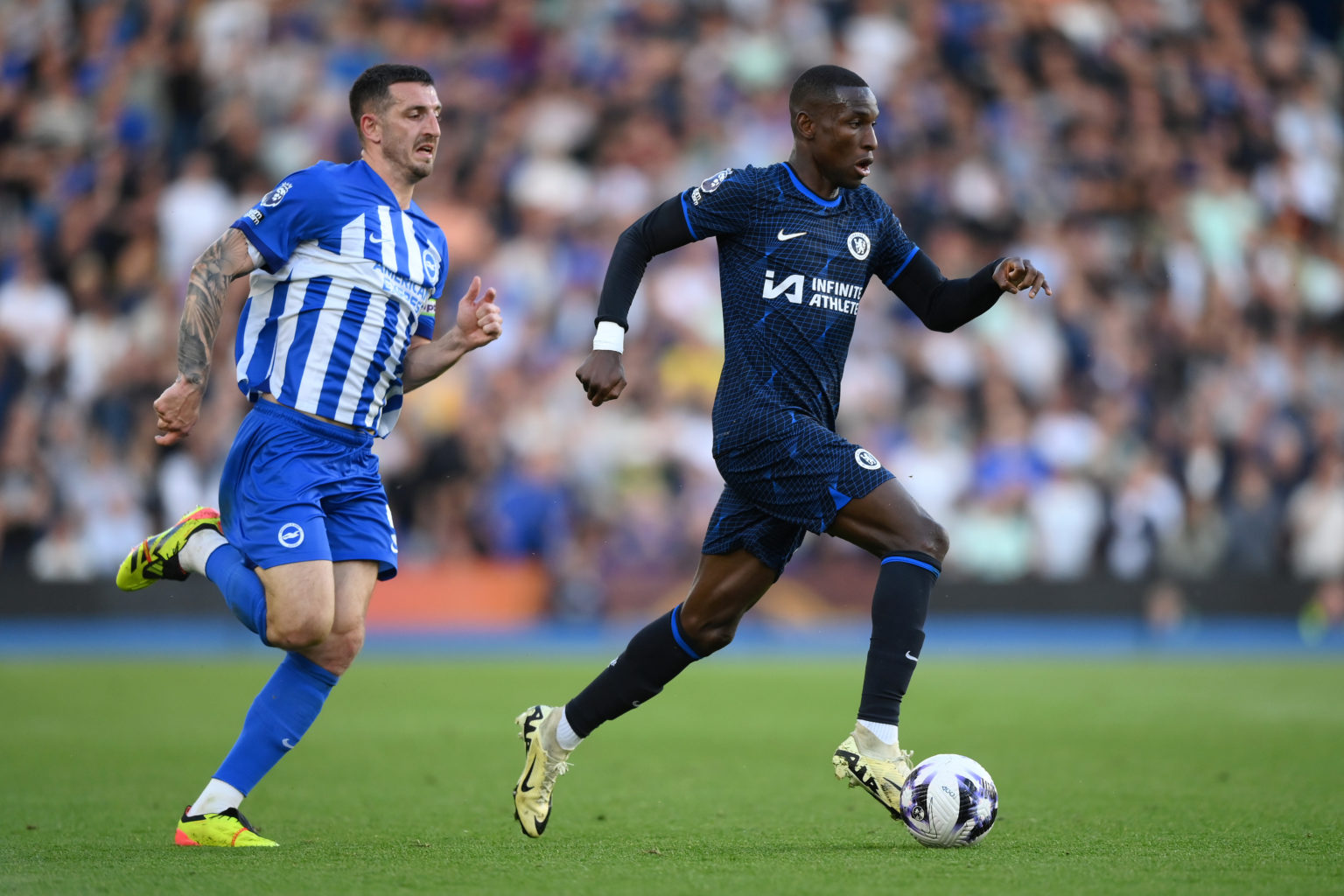 Nicolas Jackson of Chelsea takes on Lewis Dunk of Brighton & Hove Albion during the Premier League match between Brighton & Hove Albion and...