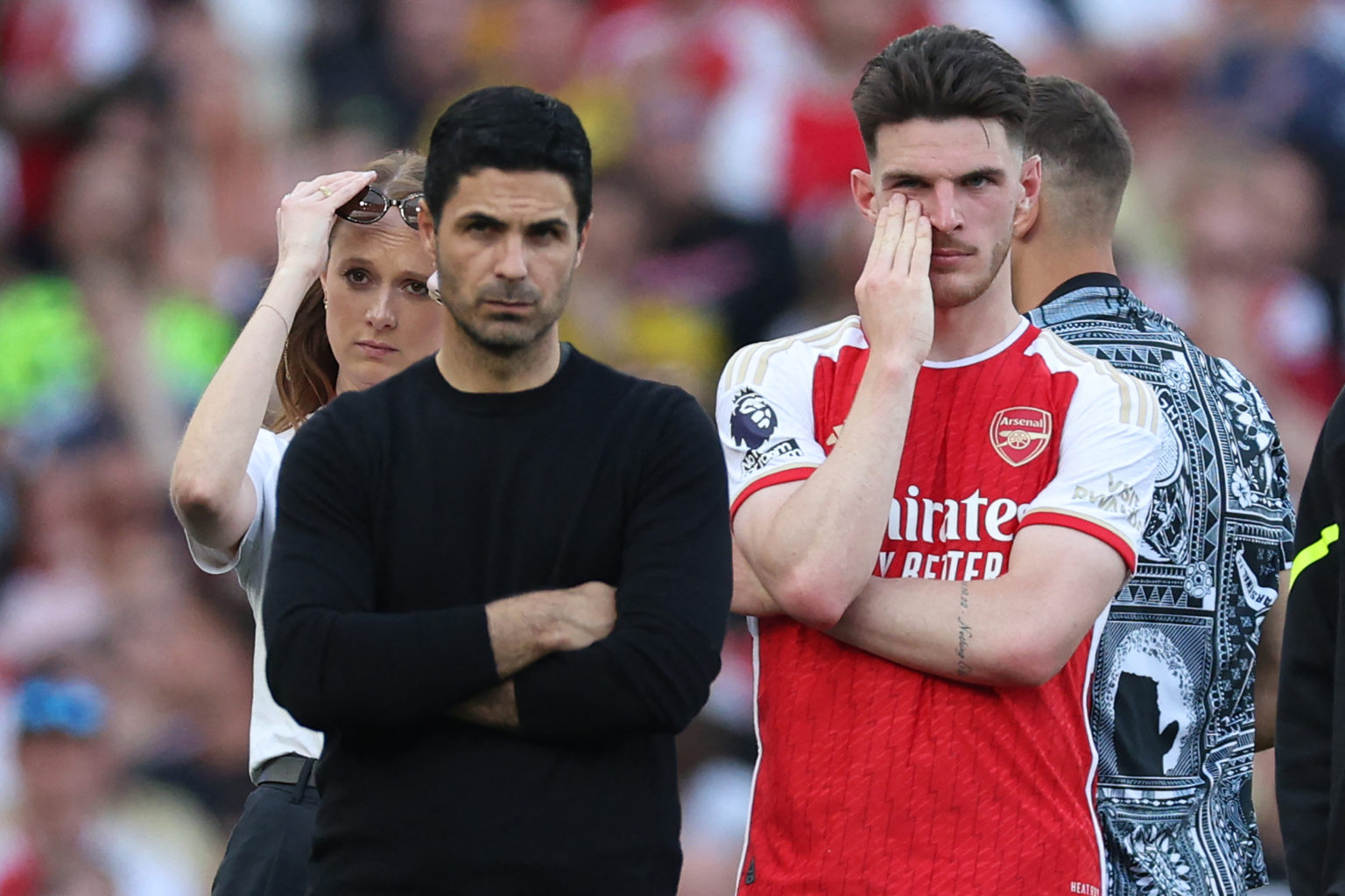 Arsenal's English midfielder #41 Declan Rice (R) and Arsenal's Spanish manager Mikel Arteta (L) react on the pitch after the English Premier League...