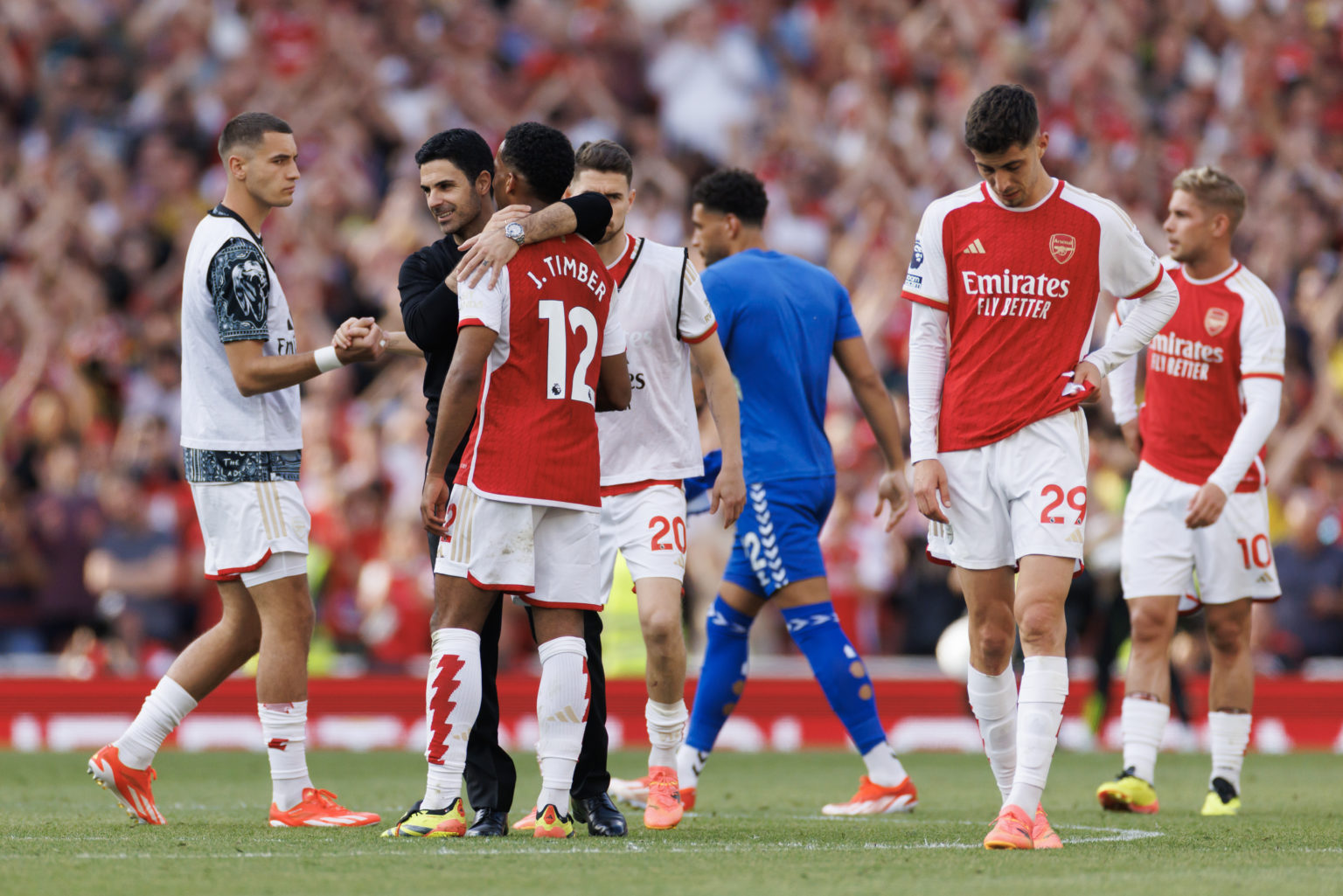 Mikel Arteta, Head Coach of Arsenal embraces Jurrien Timber as Kai Havertz looks dejected during the Premier League match between Arsenal FC and Ev...