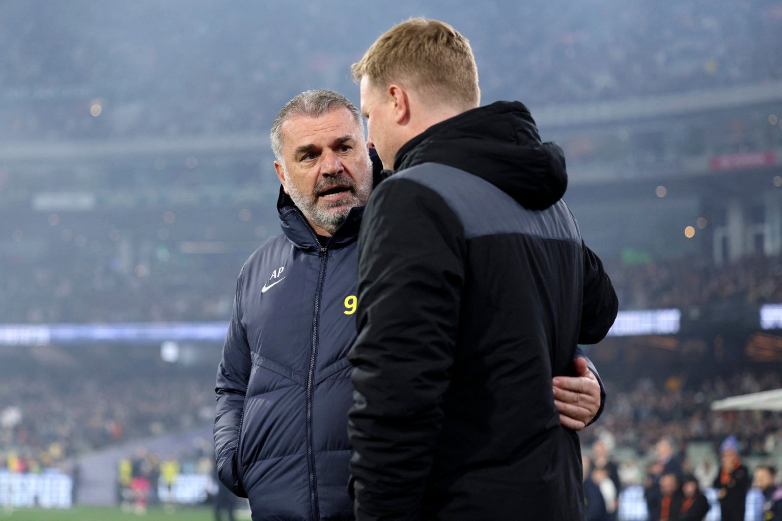 Tottenham Hotspur's head coach Ange Postecoglou (L) embraces Newcastle United's head coach Eddie Howe on the touchline during the friendly football...