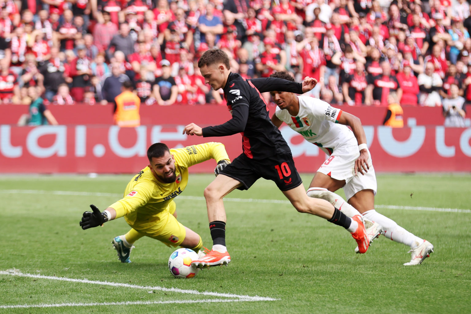 Tomas Koubek of FC Augsburg makes a save from Florian Wirtz of Bayer Leverkusen during the Bundesliga match between Bayer 04 Leverkusen and FC Augs...